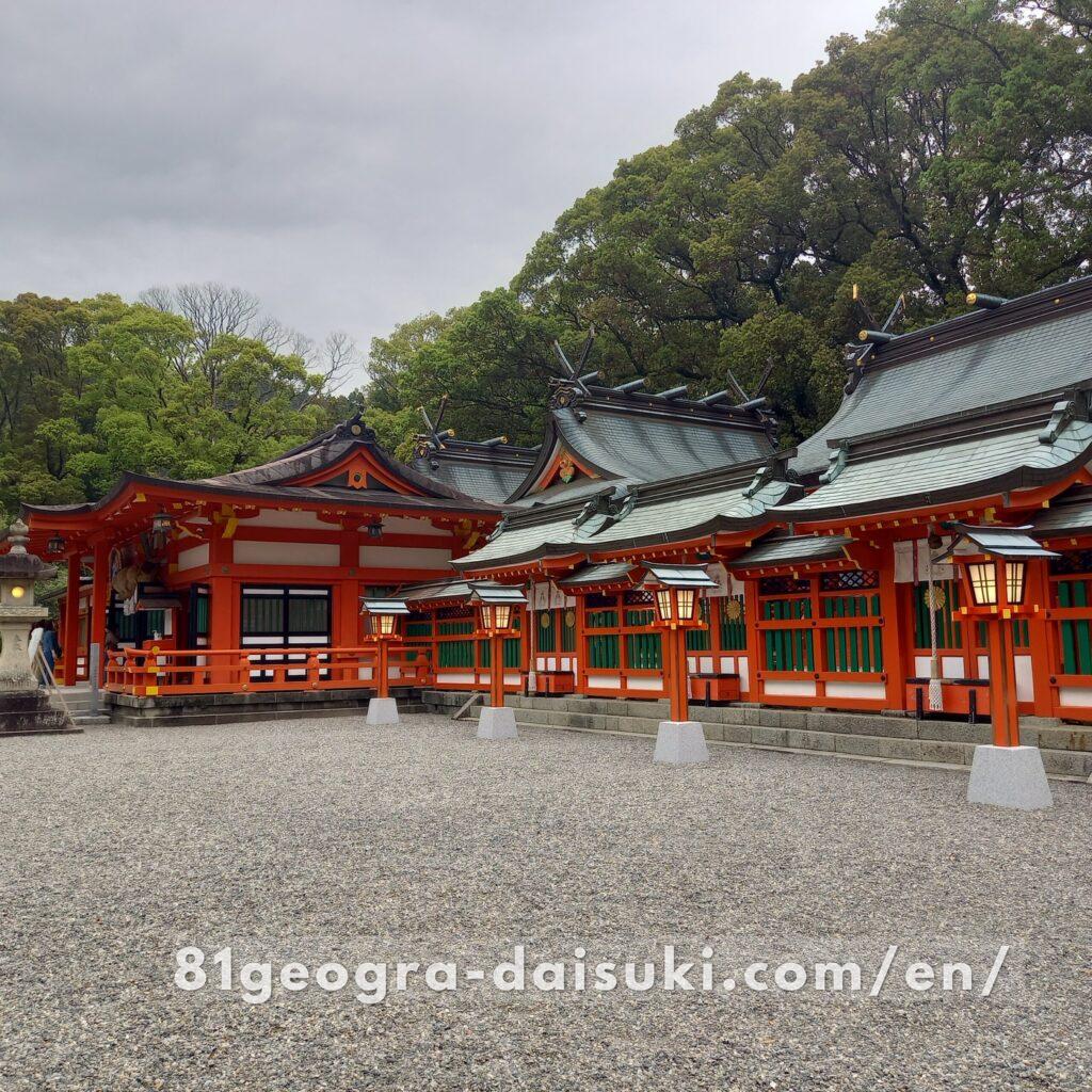 Main pavilion of Kumano Hayatama Taisha Shrine with traditional Japanese architecture and vermilion accents.