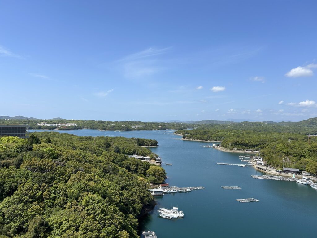 Panoramic view of Ago Bay from Shima Kanko Hotel, with pearl rafts floating on calm blue water surrounded by green islands