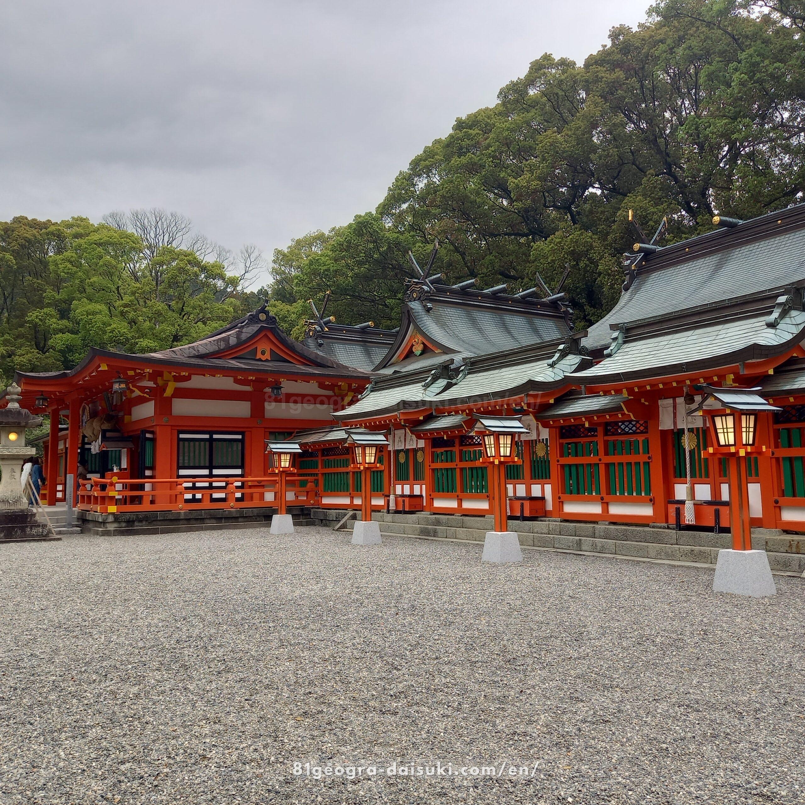 Main pavilion of Kumano Hayatama Taisha Shrine with traditional Japanese architecture and vermilion accents.