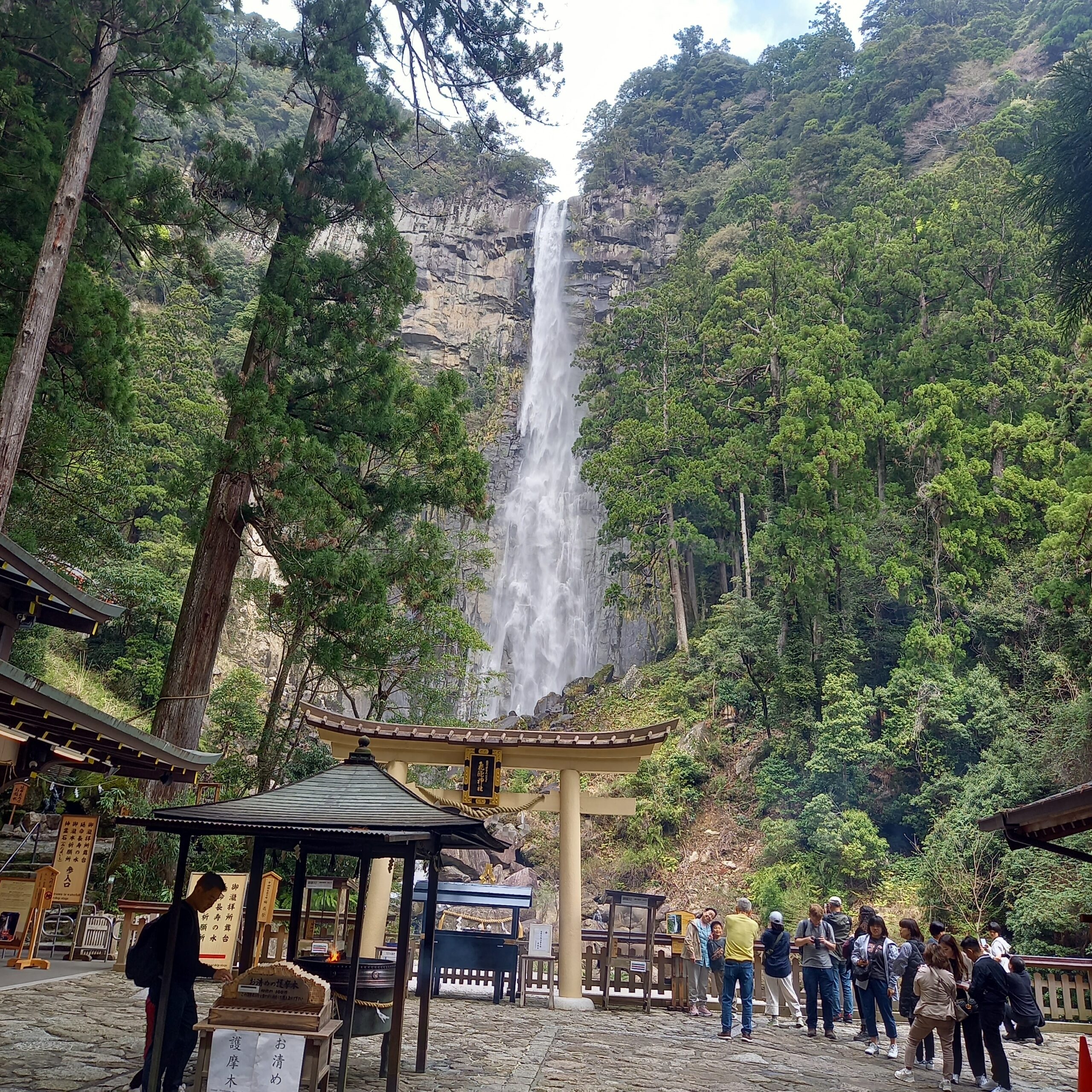 Torii gate of Hiryu Shrine with Nachi Falls towering behind