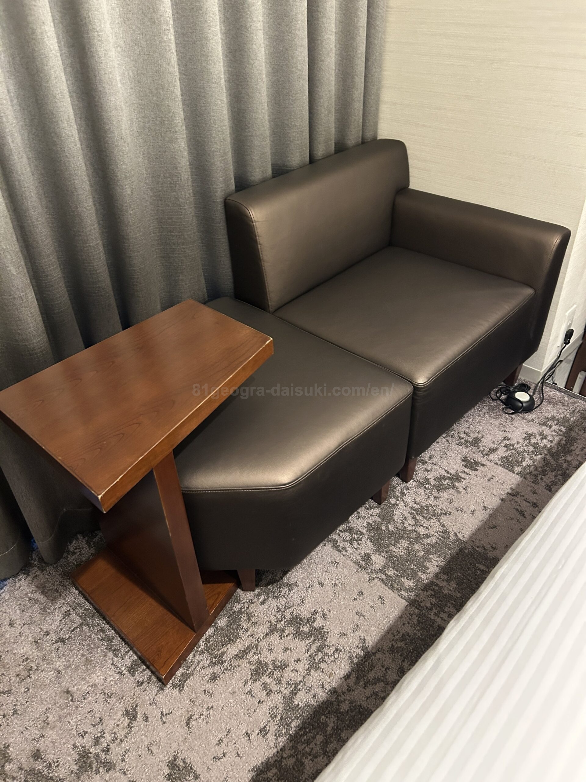 Spacious seating area by the window in the guest room