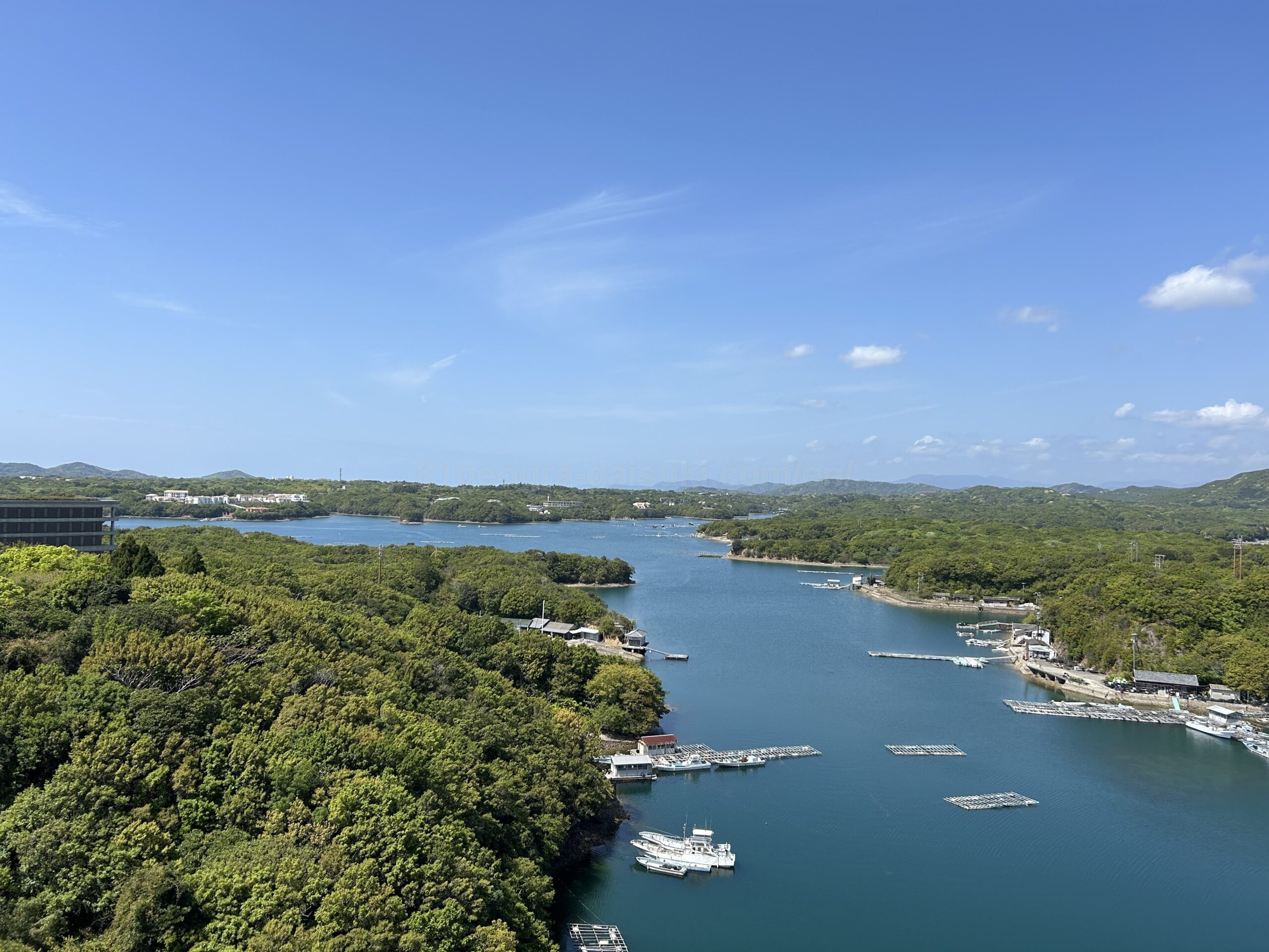 Panoramic view of Ago Bay from Shima Kanko Hotel, with pearl rafts floating on calm blue water surrounded by green islands