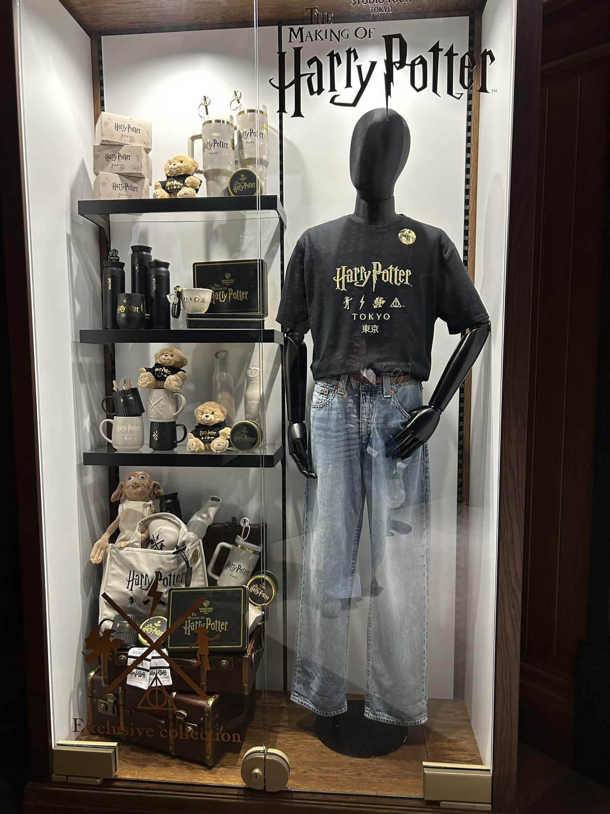 Tokyo-exclusive Harry Potter clothing and souvenirs in a glass display at Studio Tour Tokyo