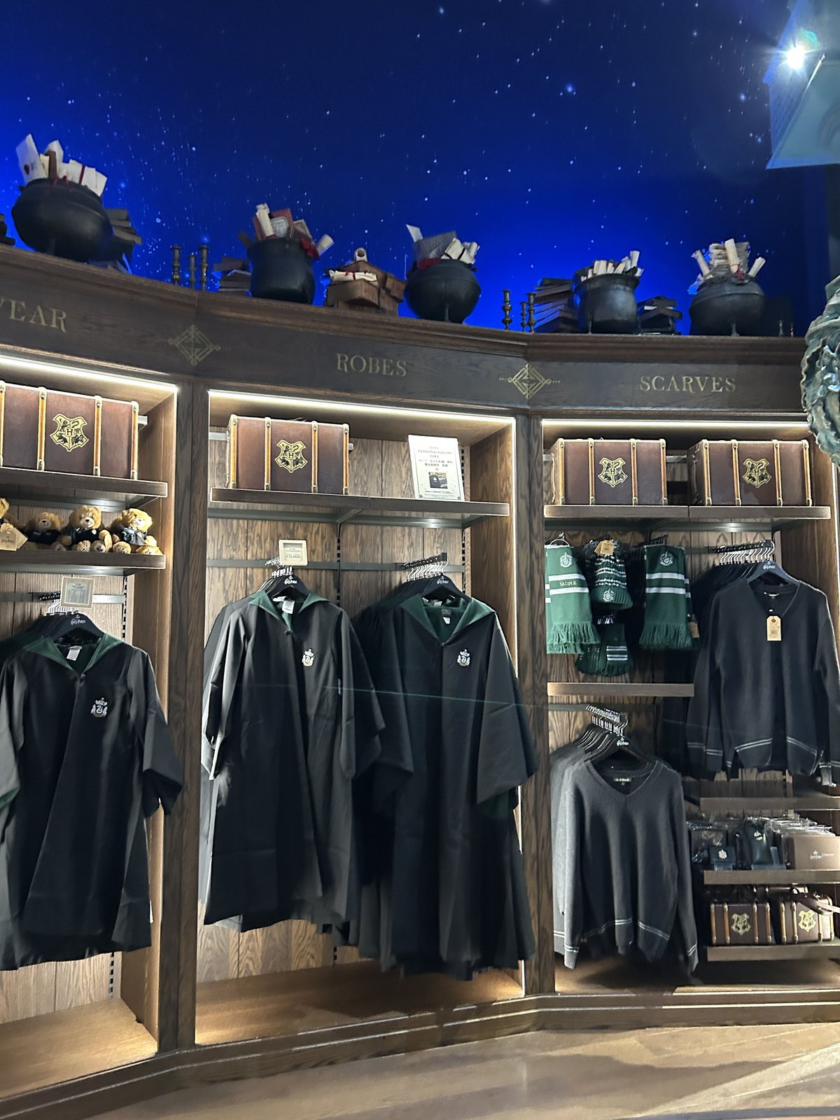 Slytherin robes, scarves and clothing displayed at Studio Tour Tokyo